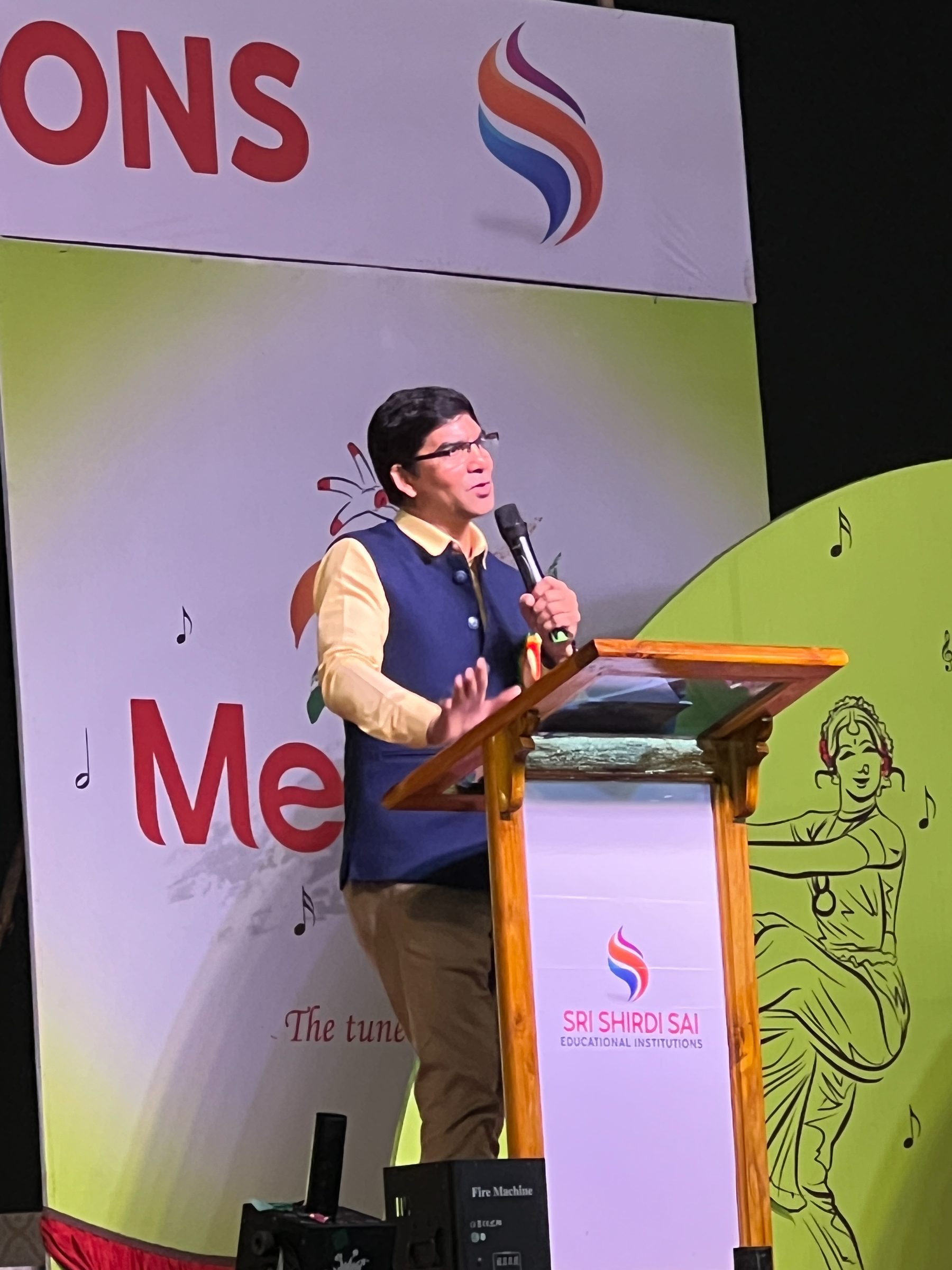 Venu Bhagavan delivering a keynote at a podium