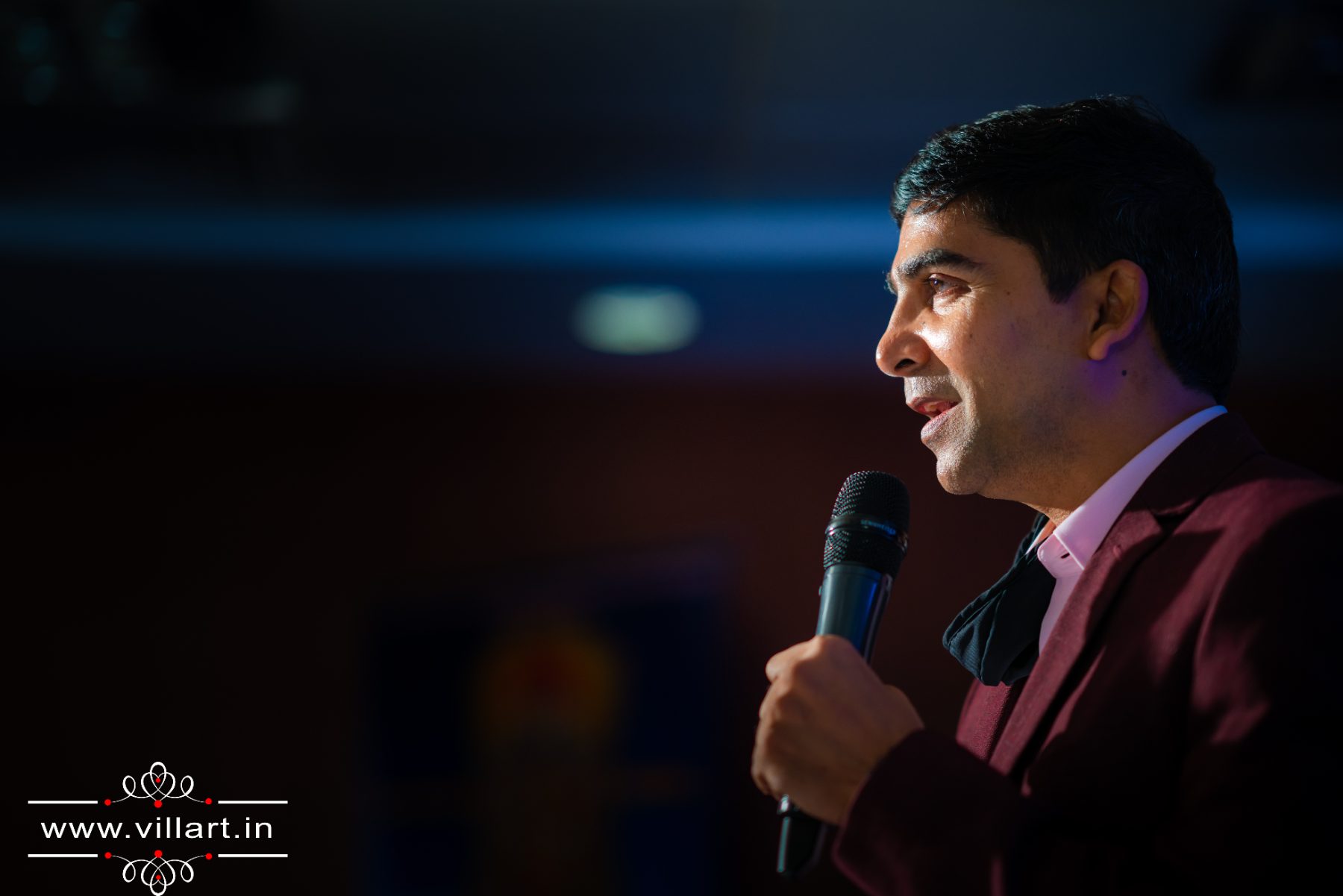 Venu Bhagavan speaking with a microphone