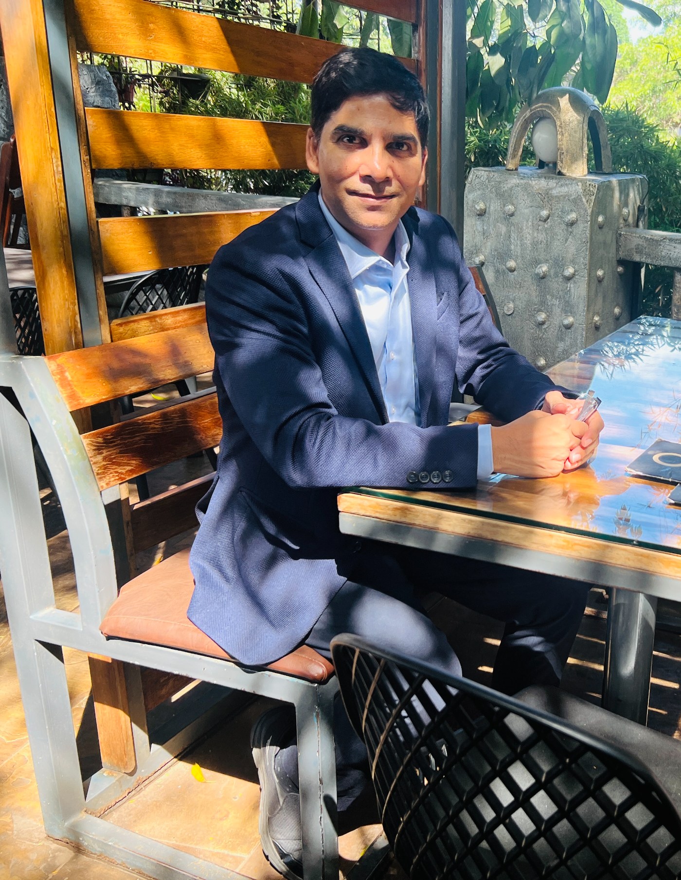 Venu Bhagavan seated at a table, ready for a private consultation